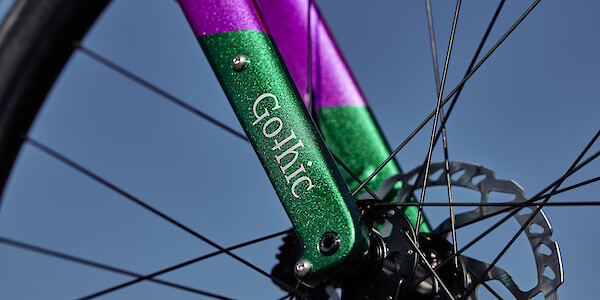 Fork detail on the custom Gothic Aix gravel bike, in glittery green and purple