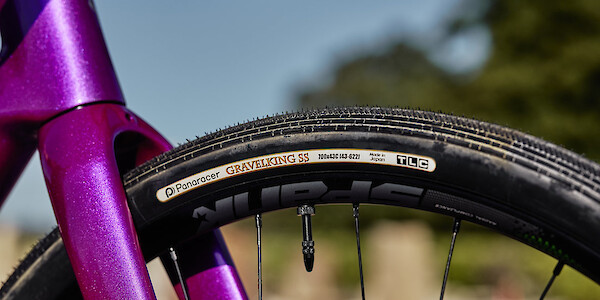 Spank wheel and Panaracer tyre detail on a custom-made purple and green Gothic Aix gravel bicycle