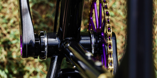 Veloci Roadmance bottom bracket with purple Garbaruk chainring and gold KMC chain